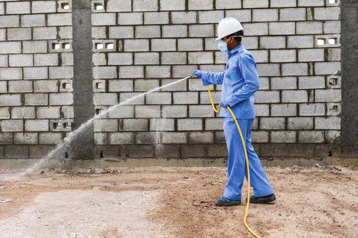 Technician applying pre-construction anti-termite treatment